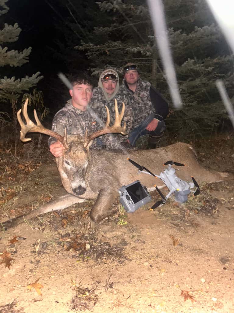 Hunters with a recovered whitetail buck after a successful nighttime drone-assisted deer recovery in Wisconsin.