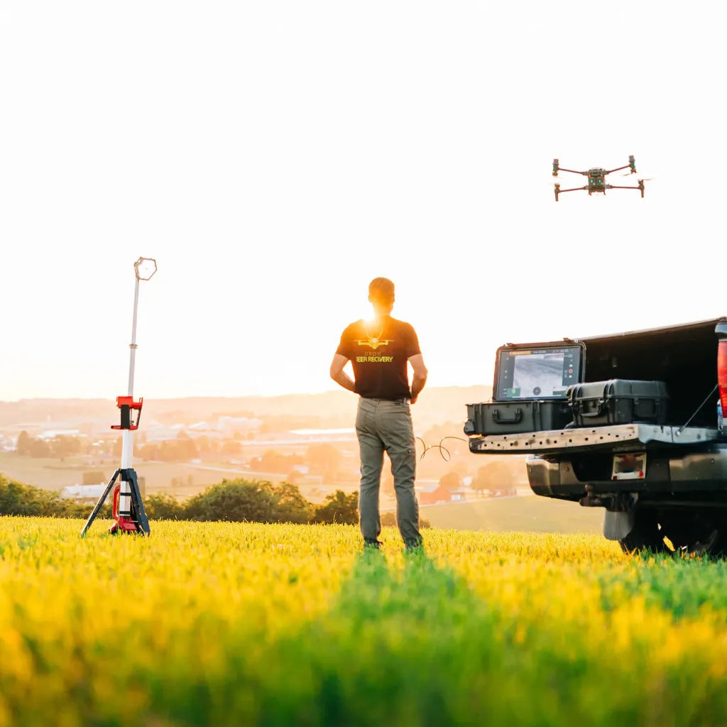 Drone pilot operating a professional drone at sunrise to assist with aerial search, recovery, and tracking services in Wisconsin.